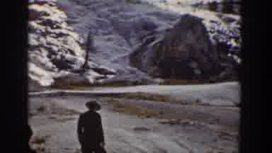 Wyoming USA (1939): Woman In Coat Walking Along Snowy Mountain Valley