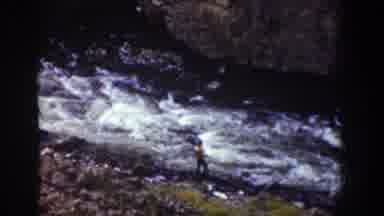 Wyoming USA (1939): Boys Standing Alongside A Rapid River As They Fish