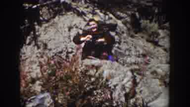 Wyoming USA (1939): A Man By A River Holding A Trash Bag And A Stick To Pick Up