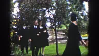 Wyoming USA (1939): People Walking Arm In Arm Outside All Dressed Nicely In Black