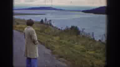 Wyoming USA (1939): Man In Trench Coat Standing On Road Along A Beautiful River