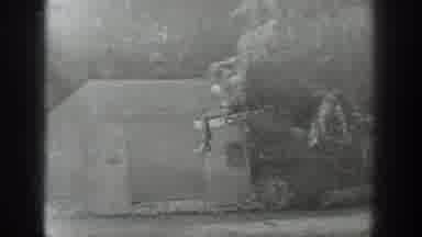 Washington USA (1940): A Man Crossing A Rapid River On A Zip Line Platform