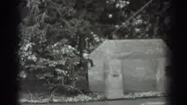 Washington USA (1940): Man Hanging Over Fast Moving Stream From Zipline In