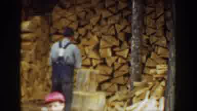 Washington USA (1940): Man Chops Wood While Boy Swings To Hit Baseball With Bat