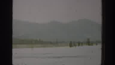 Washington USA (1940): Mountains Filmed Over Body Of Water From A Car, Jump cut To