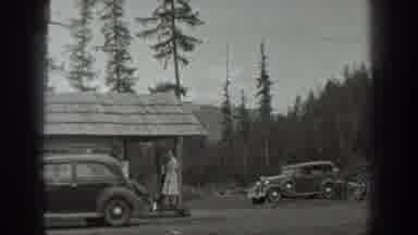 Washington USA (1940): A Woman Standing By A Covered Structure And A Group Of