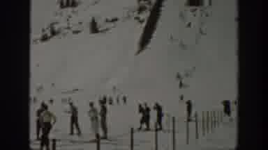 Washington USA (1940): One Person Skiing Down Hill As Other Skiers Look On