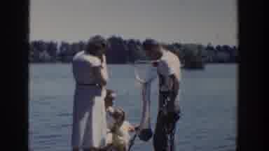Wisconsin USA-1953: Family At Lake With Fishing Net And Children