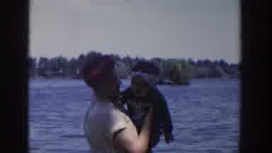 Wisconsin USA (1953): Two Mothers Playing Outside With Their Children On A Boat In