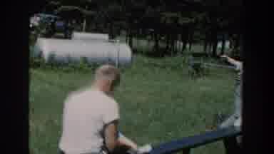Wisconsin USA (1953): Two Men Riding A Teeter Totter While Each Holding Onto A