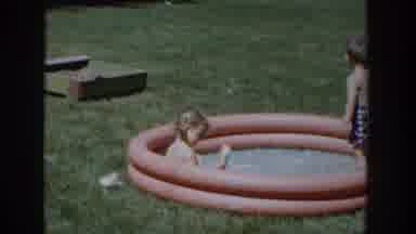 Wisconsin USA (1953): Two Children's Are Playing With Water And Some One Person Is