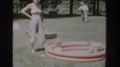 Wisconsin USA (1953): Camera Panning Across Backyard With A Mother And Her Kids
