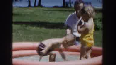 Wisconsin USA (1953): A Man And Two Children, A Boy And A Girl Play In A Small