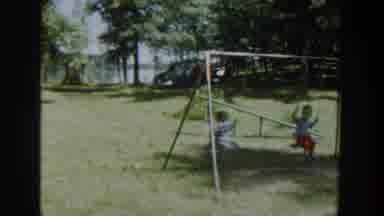 Wisconsin USA (1953): Two Kids Enjoying Swing Chair In A Park