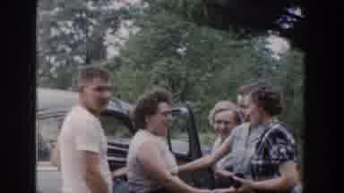 Wisconsin USA (1953): Women And A Man In A T-Shirt Standing Talking Next To Blue