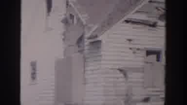 Grand Rapids Michigan USA (1956): A Man Walking Next To A House That Is Mostly