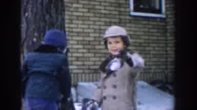 Michigan USA (1957): One Kid Is Showing Off His Snowball While His Brother Is
