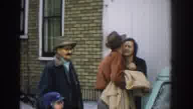 Michigan USA (1957): Couple Kissing In Group Of People By Car