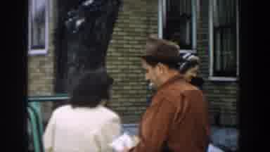 Michigan USA (1957): Man Smoking Getting Out Of A Green Car And Walking Away