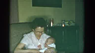 Michigan USA-1957: Mother Holding Baby On Her Lap In Living Room