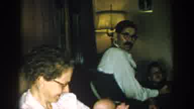 Michigan USA (1957): Woman Holds A Baby And Smiles While Man And Two Boys Look On