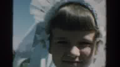 Michigan USA (1957): People Are Watching As A Young Girl In A Pretty Dress Walks