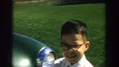 Michigan USA (1957): A Boy In Striped Shirt Looks At A Board As Another Boy With