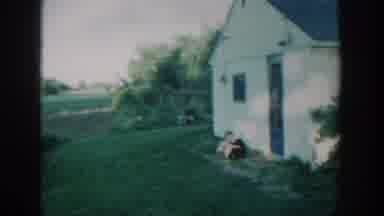 Michigan USA (1957): A Little Boy Is Playing With His Family Dog Outside