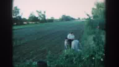 Michigan USA (1957): Child And Adults Harvesting Crops From Farm On Cloudy Day