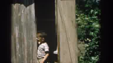 Michigan USA (1957): Boys Playing Around Shed And Playing With Their Dog Outside