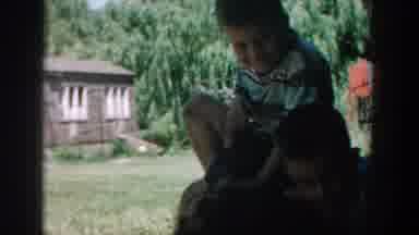 Michigan USA (1957): Three Boys Sit And Hold Each Other In The Shade