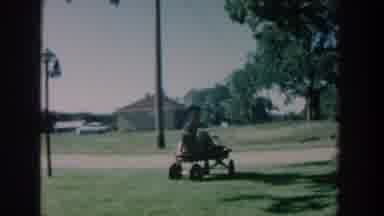 Michigan USA (1957): Family Relaxing On The Grass And Under A Tree With Child