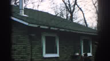Wisconsin USA (1957): Mother And Child Walk Around Brick Home Rope Tied To A Tree