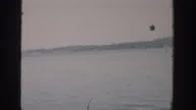 Wisconsin USA (1957): View Of Person Flapping Arm At Quiet Misty Lake Shore On