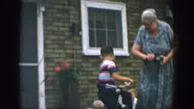Wisconsin USA (1957): Woman Wearing Dress Winds Up Small Toy For Three Children In