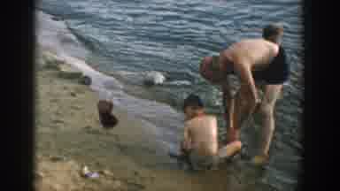 Wisconsin USA (1957): Father And Kids Playing On The Beach