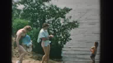 Wisconsin USA (1957): Group Of White People Go Wading Into Lake Together Wearing