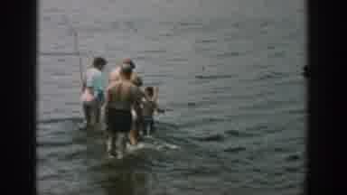 Wisconsin USA (1957): Woman Leaves Towel On The Shore And Adults And Children