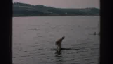Wisconsin USA (1957): Man Unsuccessfully Overturns Canoe While Onlookers Watch