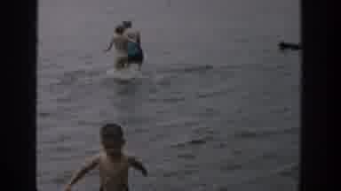 Wisconsin USA (1957): Young Family In The Water Splashing About Together Having