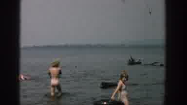 Wisconsin USA (1957): Children Are Playing In A Lake While Their Parents Watch