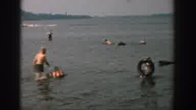 Wisconsin USA (1957): People Play And Wade In Calm Water