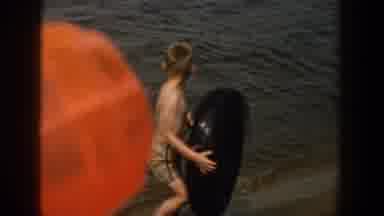 Wisconsin USA (1957): Dated Child On A Beach With Other Children And Swim Toys