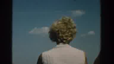 Wisconsin USA (1957): Blonde Haired Woman Wearing Sunglasses Turns To Smile At