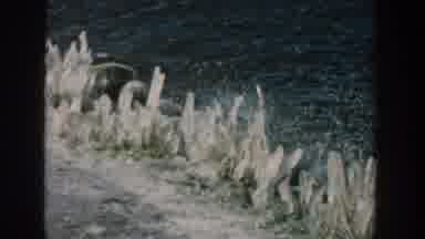 Wisconsin USA (1957): Ocean Crashing Against A Frozen Landscape In The Day Time