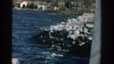Wisconsin USA (1957): Water Rushing Along Shore Hitting Large Rocks Man Standing