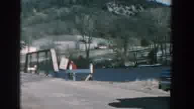 Wisconsin USA (1957): Small Waves Hit Boulders By A Small Wooden Bridge In The