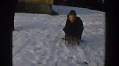 Wisconsin USA (1957): Young Boy Enjoying First Sled Of The Year