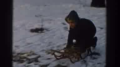 Wisconsin USA (1957): Child Pulling On A Sled And Riding It Down A Hill Of Snow
