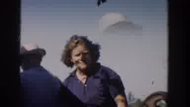 Michigan USA (1958): People Walking Around Outside While Standing Next To An Old